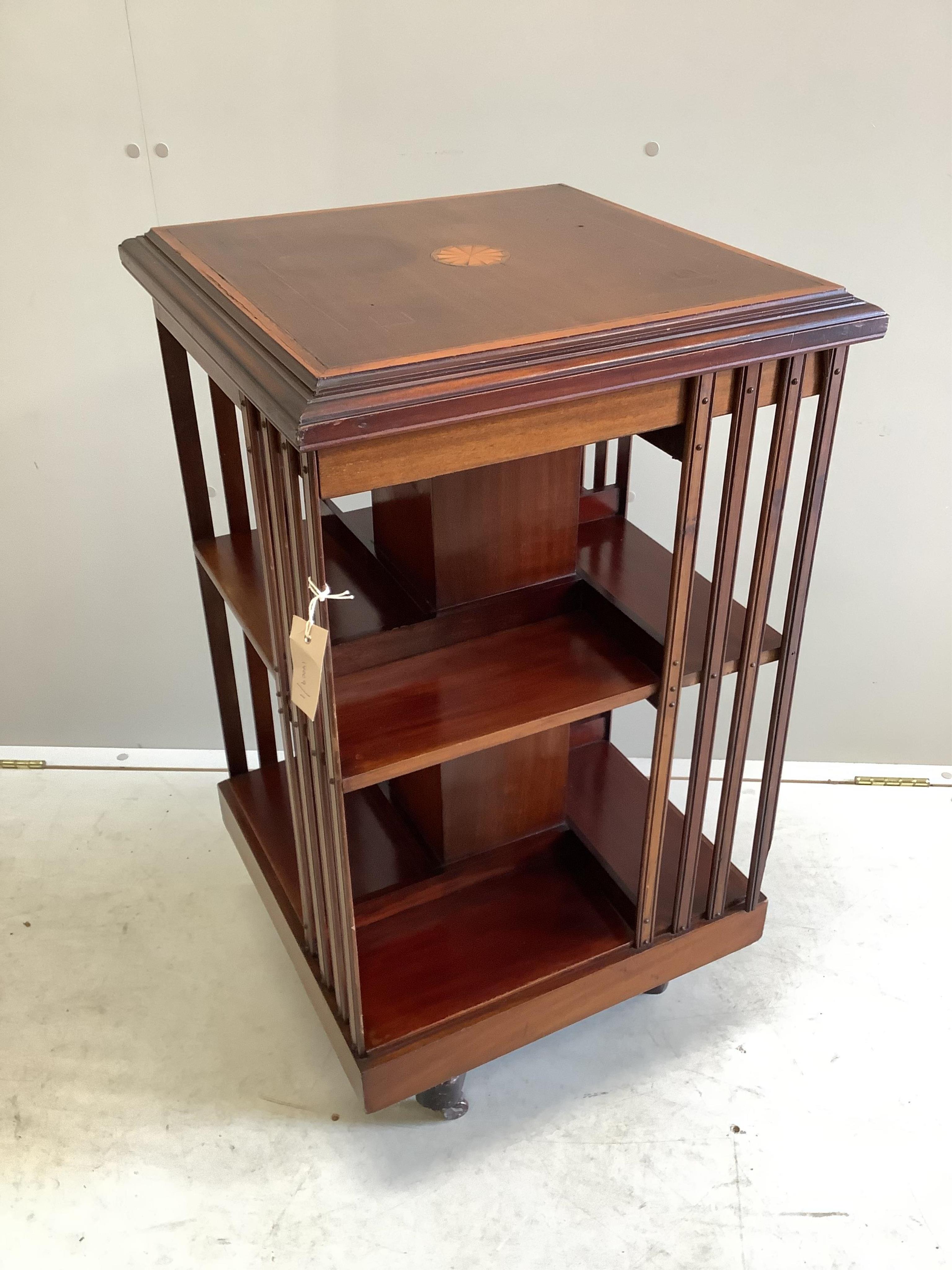 An Edwardian satinwood inlaid mahogany revolving bookcase, 48cm sq., height 88cm